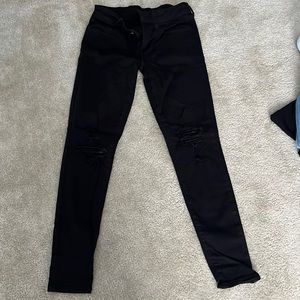 Black American Eagle jeans with rips in the knees.